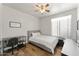 Cozy bedroom features a wood-look floor, desk, and a comfortable bed, perfect for a student or young professional at 2894 E Melody Ln, Gilbert, AZ 85234