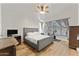 Spacious bedroom with a comfortable bed, wood floors, ceiling fan, and ample natural light at 2894 E Melody Ln, Gilbert, AZ 85234