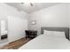 Comfortable bedroom features a wood-look floor, closet, and a simple bed, perfect for a student or minimalist at 2894 E Melody Ln, Gilbert, AZ 85234