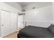 This bedroom features a wood-look floor, closet, and a simple bed, perfect for a student or minimalist at 2894 E Melody Ln, Gilbert, AZ 85234
