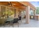 This covered patio features a wood ceiling with ceiling fans, and dining furniture at 2894 E Melody Ln, Gilbert, AZ 85234