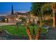 Charming exterior view with well-maintained landscaping, lush green lawn, and a welcoming three-car garage at 2894 E Melody Ln, Gilbert, AZ 85234
