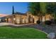 Well-lit and landscaped front exterior showcasing a beautifully maintained yard and a cozy ambiance at 2894 E Melody Ln, Gilbert, AZ 85234