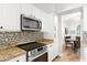 Kitchen area featuring stainless steel oven, microwave, and granite countertops at 2894 E Melody Ln, Gilbert, AZ 85234