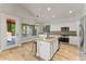 Bright kitchen featuring an island with seating and stainless steel appliances at 2894 E Melody Ln, Gilbert, AZ 85234