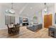 Open-concept living space with wood floors, a gray sectional sofa, dining table, and ample natural light at 2894 E Melody Ln, Gilbert, AZ 85234