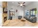 Comfortable living room featuring a stone fireplace and natural light at 2894 E Melody Ln, Gilbert, AZ 85234