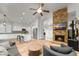 Open concept living area with modern kitchen, stone fireplace, and comfortable seating at 2894 E Melody Ln, Gilbert, AZ 85234