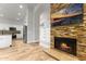 Living room view of the stone fireplace with inset television at 2894 E Melody Ln, Gilbert, AZ 85234