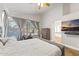 Main bedroom featuring a pool view, a TV, a ceiling fan and ensuite bathroom at 2894 E Melody Ln, Gilbert, AZ 85234