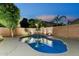 Inviting pool with lush landscaping and subtle lighting, creating a private backyard oasis at 2894 E Melody Ln, Gilbert, AZ 85234