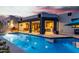 Beautiful backyard with a sparkling pool, covered patio, and outdoor lounge area at 37646 N Dream St, Carefree, AZ 85377