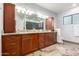 Spacious bathroom featuring and wooden cabinets, double sinks, and granite counters at 37646 N Dream St, Carefree, AZ 85377