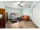 Exercise room with treadmill, sofa, ceiling fan, and shuttered window at 37646 N Dream St, Carefree, AZ 85377