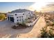 Stunning desert home boasts mountain views, a crisp white facade, and low-maintenance desert landscaping at 37646 N Dream St, Carefree, AZ 85377