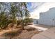 Well-maintained front yard with desert landscaping, mature trees, and a walkway at 37646 N Dream St, Carefree, AZ 85377