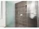 Modern shower with gray tile, glass doors, and chrome fixtures at 37646 N Dream St, Carefree, AZ 85377