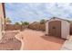 Spacious backyard with gravel, a shed, and low-maintenance landscaping at 38167 W Santa Clara Ave, Maricopa, AZ 85138