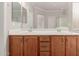 Bathroom showcasing double sink vanity with wood cabinets and large mirror at 38167 W Santa Clara Ave, Maricopa, AZ 85138