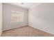 Bedroom with neutral carpet, window, and ample space at 38167 W Santa Clara Ave, Maricopa, AZ 85138