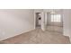 Carpeted bedroom with closet and access to other rooms at 38167 W Santa Clara Ave, Maricopa, AZ 85138