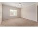 Spacious bedroom featuring neutral paint, carpet, and a ceiling fan for comfort at 38167 W Santa Clara Ave, Maricopa, AZ 85138