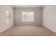 Neutral bedroom with carpet flooring and a bright window at 38167 W Santa Clara Ave, Maricopa, AZ 85138
