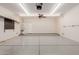 Spacious three car garage with epoxy flooring, fan, and storage at 38167 W Santa Clara Ave, Maricopa, AZ 85138
