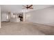 Inviting living room with neutral carpet and view of the kitchen at 38167 W Santa Clara Ave, Maricopa, AZ 85138