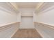 Walk-in closet with ample shelving and rods, offering generous storage space at 38167 W Santa Clara Ave, Maricopa, AZ 85138