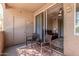 Relaxing balcony with chairs, table and sliding door that provides access to indoors at 3830 E Lakewood E Pkwy # 2042, Phoenix, AZ 85048