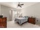 Comfortable bedroom with a ceiling fan, bedside tables, and a window with natural light at 3830 E Lakewood E Pkwy # 2042, Phoenix, AZ 85048