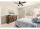Comfortable bedroom features a ceiling fan, carpeted floors and a large dresser with drawers at 3830 E Lakewood E Pkwy # 2042, Phoenix, AZ 85048