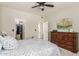 Bright bedroom has carpeted floors, ceiling fan, a large dresser and walk in closet at 3830 E Lakewood E Pkwy # 2042, Phoenix, AZ 85048