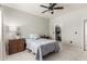 Cozy bedroom features a ceiling fan, a comfy bed and an organized walk in closet at 3830 E Lakewood E Pkwy # 2042, Phoenix, AZ 85048