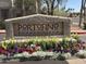 Stone monument sign reading 'Portofino Condominiums' surrounded by colorful flowers and greenery at 3830 E Lakewood E Pkwy # 2042, Phoenix, AZ 85048