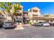 Exterior shot of condo building with covered parking, and manicured landscaping on a bright, sunny day at 3830 E Lakewood E Pkwy # 2042, Phoenix, AZ 85048