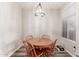 Bright dining room with wood-look flooring and a four-chair dining set at 3830 E Lakewood E Pkwy # 2042, Phoenix, AZ 85048