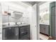 Well organized laundry room with modern washer and dryer adjacent to bathroom at 3830 E Lakewood E Pkwy # 2042, Phoenix, AZ 85048