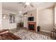 Open living space with fireplace, television, wood-look flooring, and view of the dining area at 3830 E Lakewood E Pkwy # 2042, Phoenix, AZ 85048