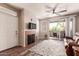 Cozy living room with balcony access, fireplace, and a comfortable brown leather couch at 3830 E Lakewood E Pkwy # 2042, Phoenix, AZ 85048