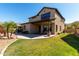 Spacious backyard with a covered patio, lush lawn, and manicured landscaping, great for outdoor activities at 3914 E Constance Way, Phoenix, AZ 85042