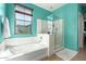Spa-like bathroom with a soaking tub, separate shower, and window with serene views at 3914 E Constance Way, Phoenix, AZ 85042
