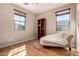 Bright bedroom with hardwood floors, a comfortable chaise lounge, and plenty of natural light at 3914 E Constance Way, Phoenix, AZ 85042
