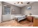Cozy bedroom with paneled walls, hardwood floors, and a comfortable bed filled with natural light at 3914 E Constance Way, Phoenix, AZ 85042