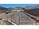 A desert-landscaped drainage area with a metal safety railing between houses in the community at 3914 E Constance Way, Phoenix, AZ 85042
