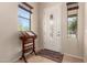 Bright entryway featuring tile flooring, decorative door, and natural light from two windows at 3914 E Constance Way, Phoenix, AZ 85042