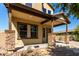 Home's spacious front porch with decorative stone pillars and desert landscaping at 3914 E Constance Way, Phoenix, AZ 85042