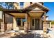 Home's inviting front porch with stone pillars and low maintenance desert landscaping at 3914 E Constance Way, Phoenix, AZ 85042
