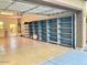 Spacious three car garage featuring epoxy floors, storage shelves, and utility access door at 3914 E Constance Way, Phoenix, AZ 85042